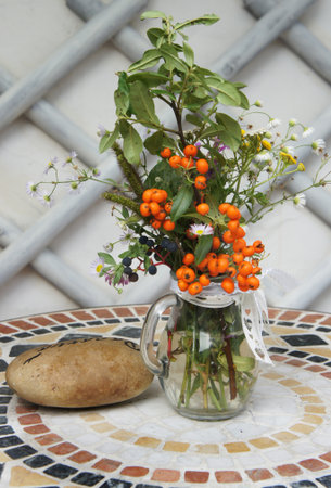 Beautiful terrace with a table and seasonal flowers