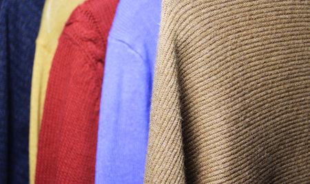 Mix of vivid multicolored knitwear in the dressing roomの写真素材