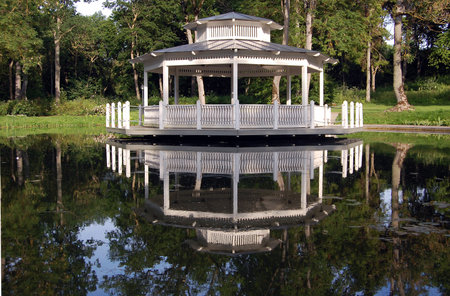 Old white wooden pavilion near the bondの写真素材