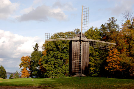 Old wooden windmill in the park at autumnの写真素材