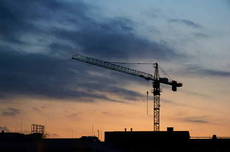 Crane silhouette over the sunset at the construction siteの写真素材