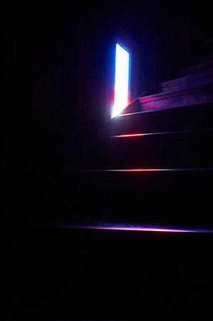 Metal staircase in the dark room with gloomy lightsの写真素材