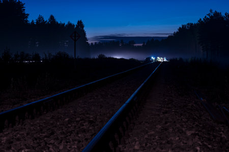 Railway leading to railroad maintenance work done in the night 