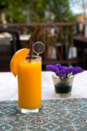 ripe mango smoothie on dinning tableの写真素材
