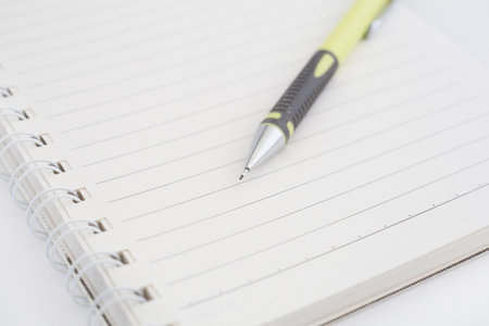an empty notebook with pencilの写真素材
