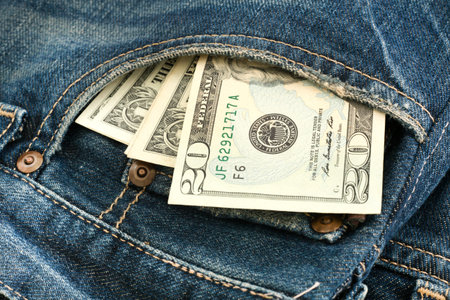 close up of US Dollar bill on jean