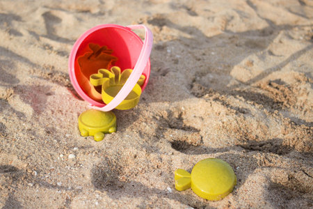 Pink and green beach toys on the beach.の写真素材