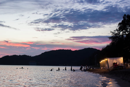 Waterfront cottage on the beach with twiligh sky.