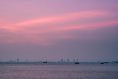 Sea in the evening with purple sky and fishing boat.の写真素材
