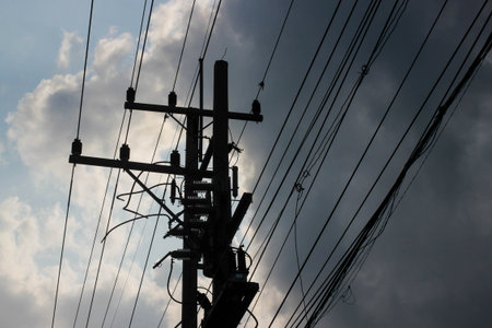 Silhouette electric pole with cloudy on sky.の写真素材