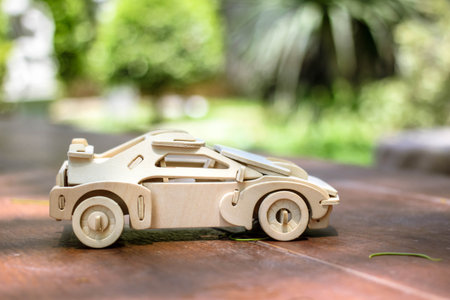 Wooden car model with blur outdoor background.の写真素材