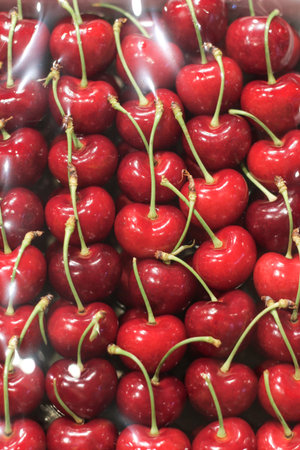 Red cherry in the box cover whith plastic in supermarket.