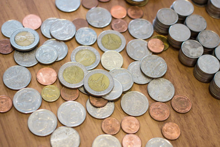 Group of Thai baht coin on wooden floor.の写真素材