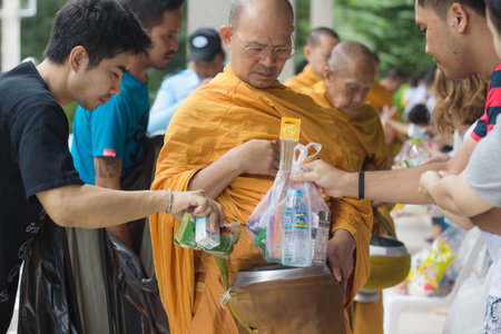 CHONBURI, THAILAND - AUGUST 20, 2016: People  givng food to the monks in Lumpini condo.のeditorial素材