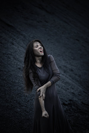 Beautiful sad girl on a mound of coalの写真素材