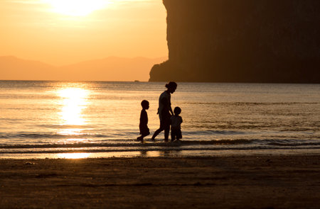 mom and sons on the beachの写真素材