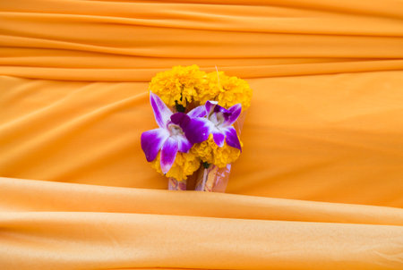 yellow cloth and flower in buddhist ceremonyの写真素材