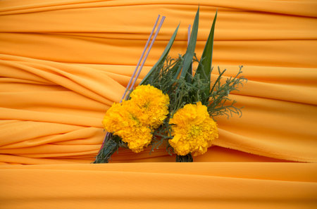 yellow cloth and yellow flower in buddhist ceremony