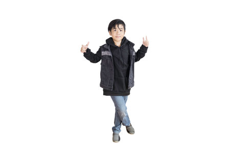 Portrait of a young Asian elementary school student wearing a cute jeans and black coatの写真素材