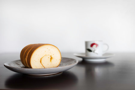 Jam rolls placed on a plate on a wooden table to eat with coffee.	
の写真素材