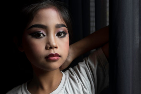 Portrait of an Asian schoolgirl who has been makeup to prepare to perform on stage.の写真素材