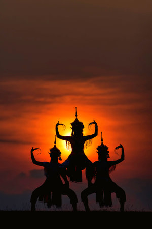 The black silhouette of three Manohra actors dancing in the park in the evening. Manohra performance...