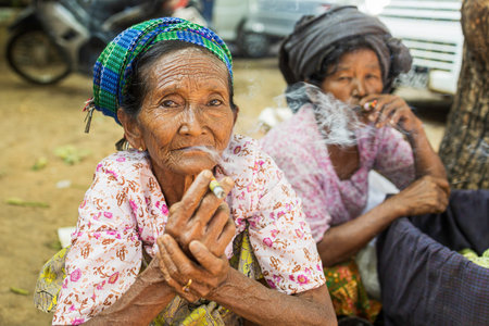 Bagan/Myanmar-October 5th 2019: Burmese elderly women are sitting and smoking, made from local herbs that are popular with Burmese people.のeditorial素材