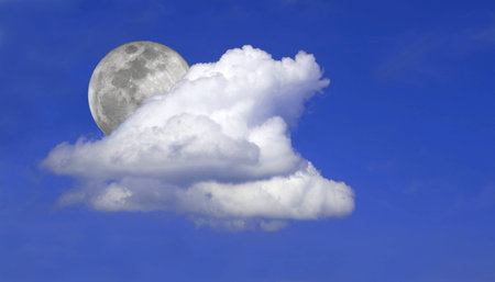 Blue sky with clouds and moonの写真素材