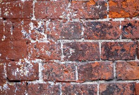 Old red brick wall with cracks