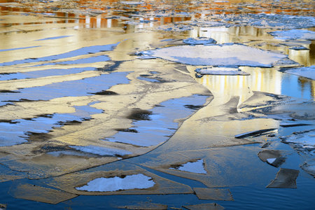 sunlit drifting ice floe on the river in winter