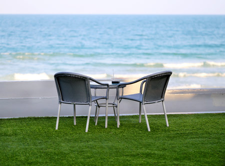 beautiful table and chairs on the beach in the tropicsの写真素材