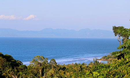 Beautiful ocean views with high mountains covered by jungleの写真素材