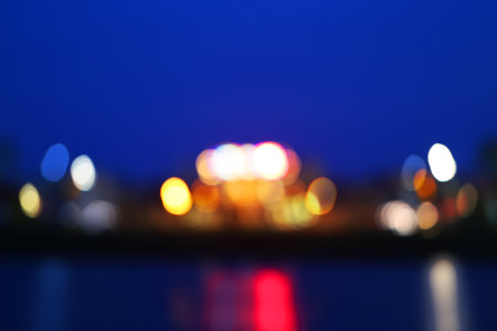 Abstract blurred city lights in the evening over the water in the pondの写真素材