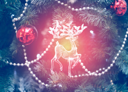Bright photo background Christmas tree with toy reindeerの写真素材