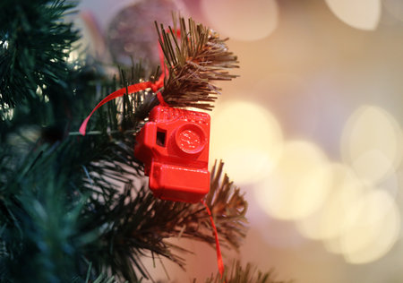 Bright photo background Christmas tree with a toy cameraの写真素材