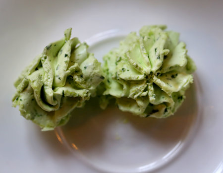 Photos of green butter in a white plateの写真素材