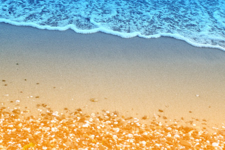 Photo of a beautiful blue wave and sandbag pebblesの写真素材