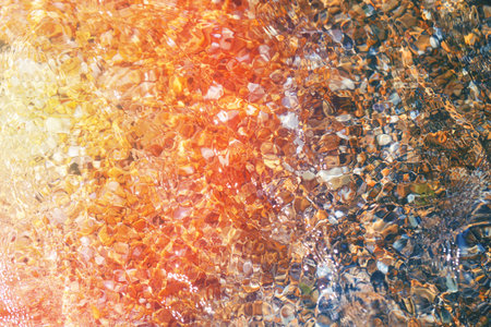 Photo background of transparent sea water with pebbles on the beachの写真素材