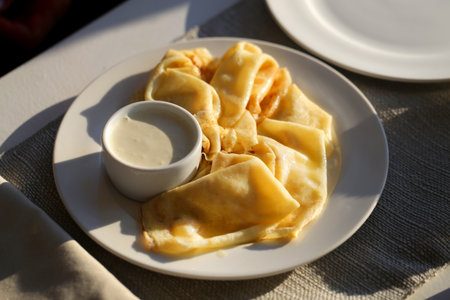 Photo of macro sweet pancakes with cinnamon and apples in a cafeの写真素材