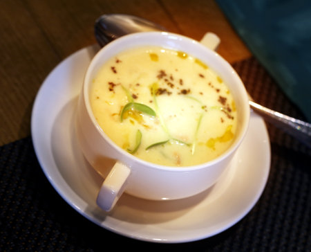Photo of a bright macro of delicious vegetable soup in a cafeの写真素材
