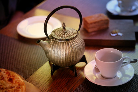Photo of a macro tea-drinking tea-box with a cake on a table in a restaurantの写真素材