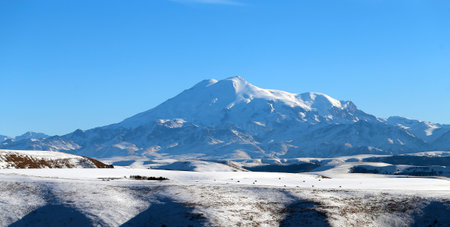 Photo of the beautiful landscape of snowy blue Elbrus in the distance in the North Caucasus