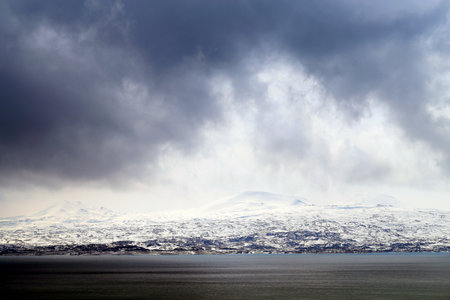 Photo background mountain landscape on a cloudy snowy day in Armenia on Sevan