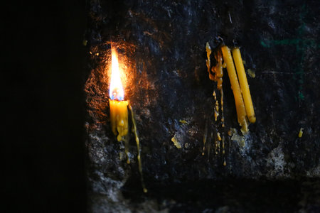 Photo background close-up beautiful flame bright candles in Armenian temple