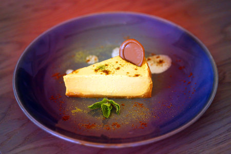 Photo of beautiful macro sweet chocolate cake cheesecake with chocolate in a restaurantの写真素材