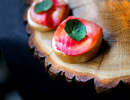 Macro photo of delicious red fish sandwich on wooden backgroundの写真素材