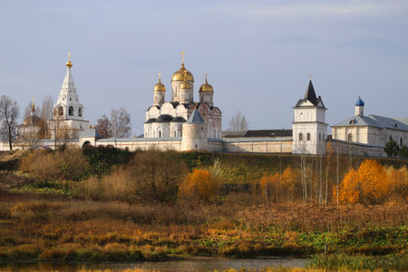 Beautiful autumn photo of an Orthodox monastery on the river Bank in Mozhaiskの写真素材