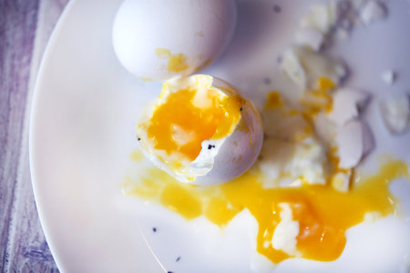 Photos of delicious eggs on a white plate