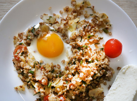 Photos of delicious eggs and vegetables for breakfast in a white plateの写真素材