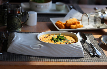 Photo of a cute hungry kitten in the autumn parkの写真素材